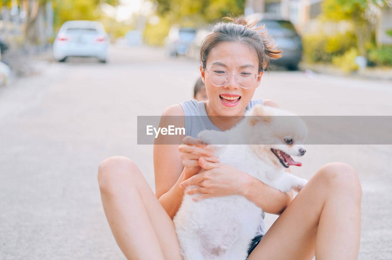 WOMAN WITH DOG SITTING IN CAR