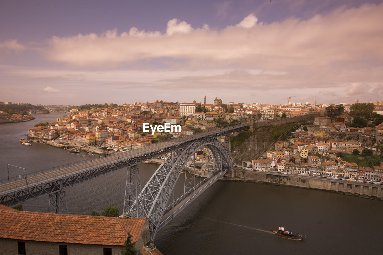 Dom luis i bridge over douro river by city against sky