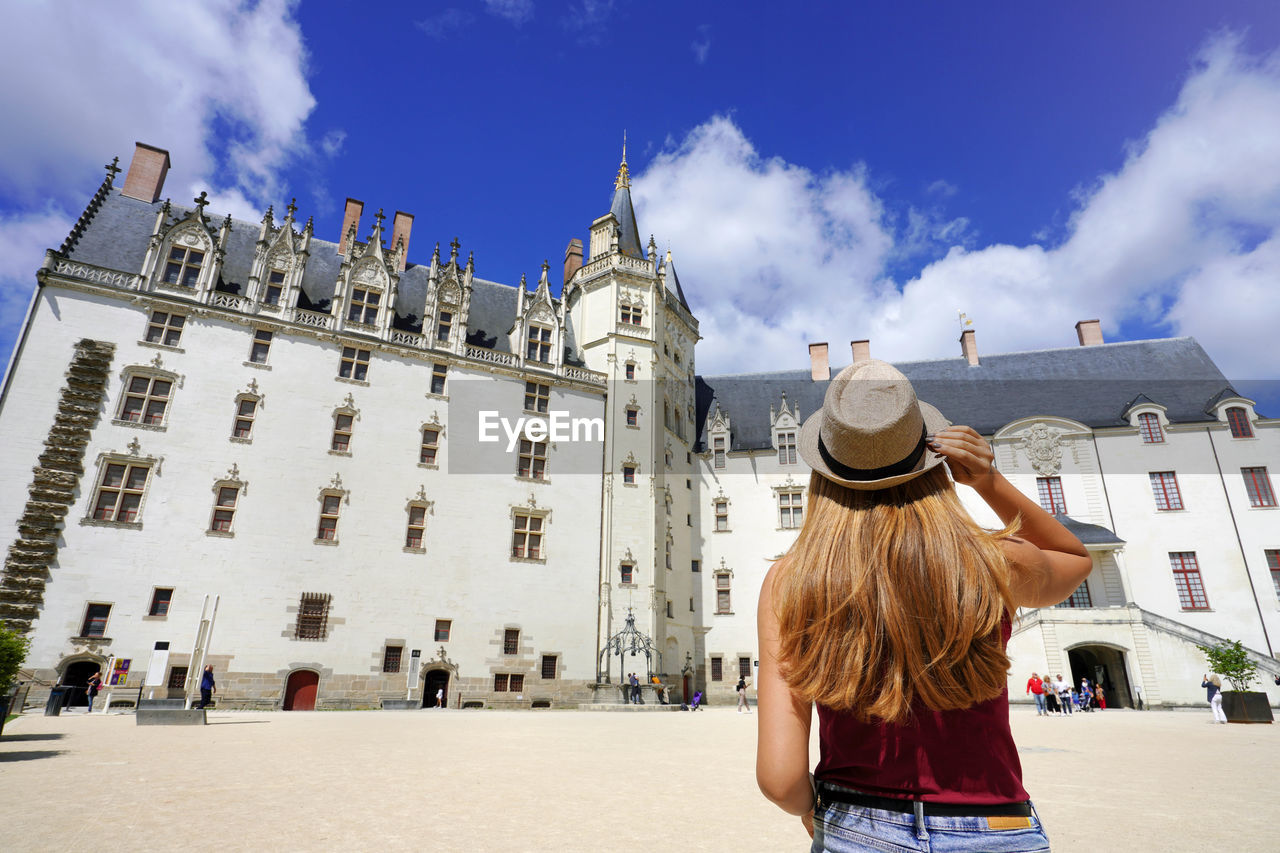 Young traveler woman visiting the château des ducs de bretagne a castle in the city of nantes france