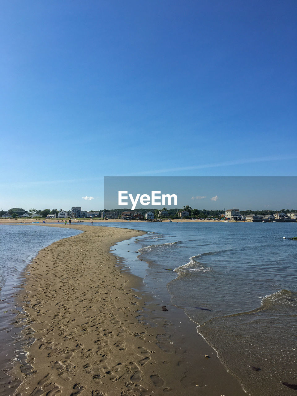 Scenic view of beach against clear blue sky