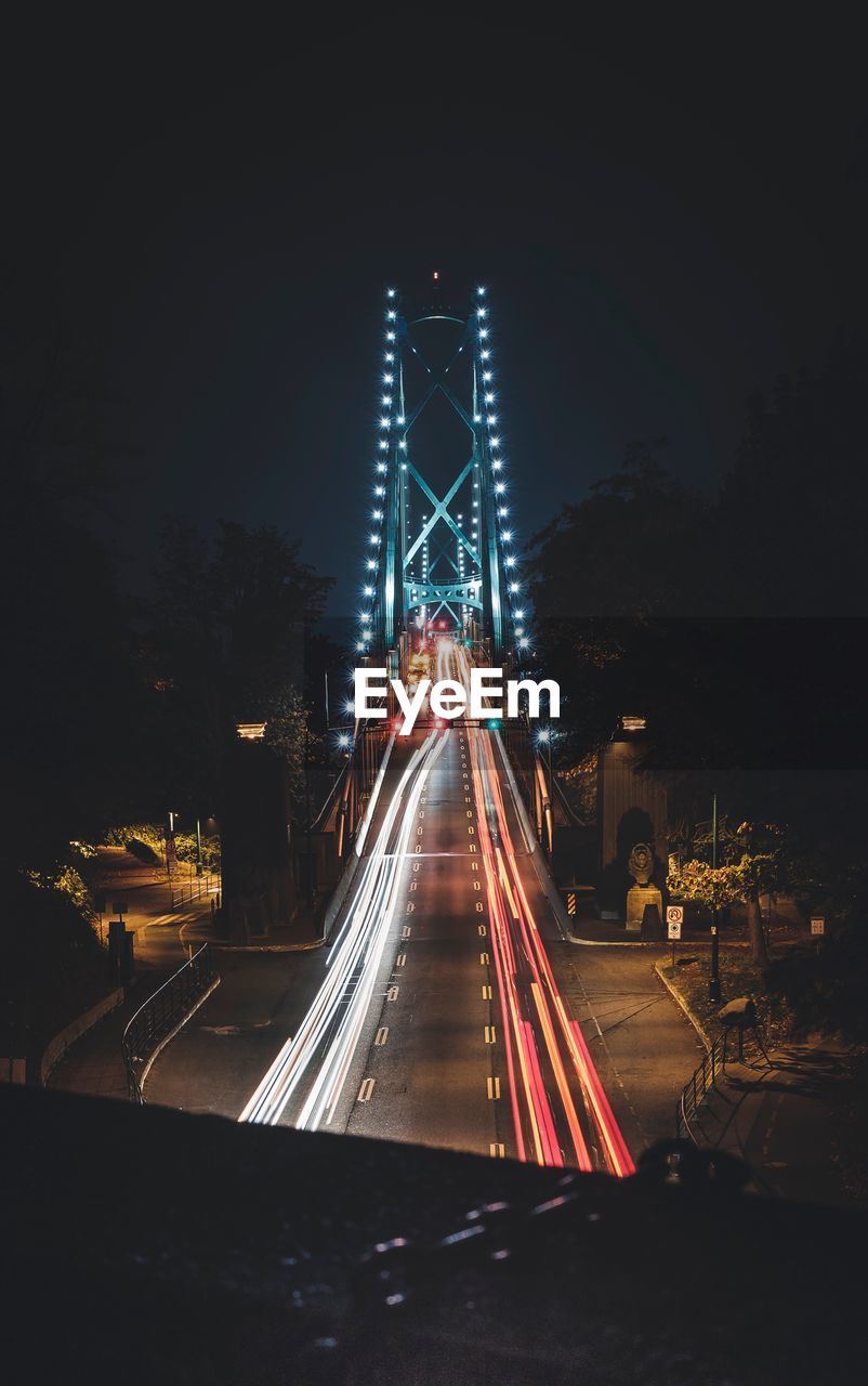 High angle view of light trails on bridge at night