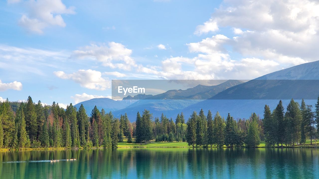 Scenic view of lake and mountains against sky