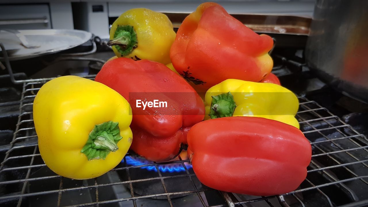 CLOSE-UP OF MULTI COLORED BELL PEPPERS IN CONTAINER