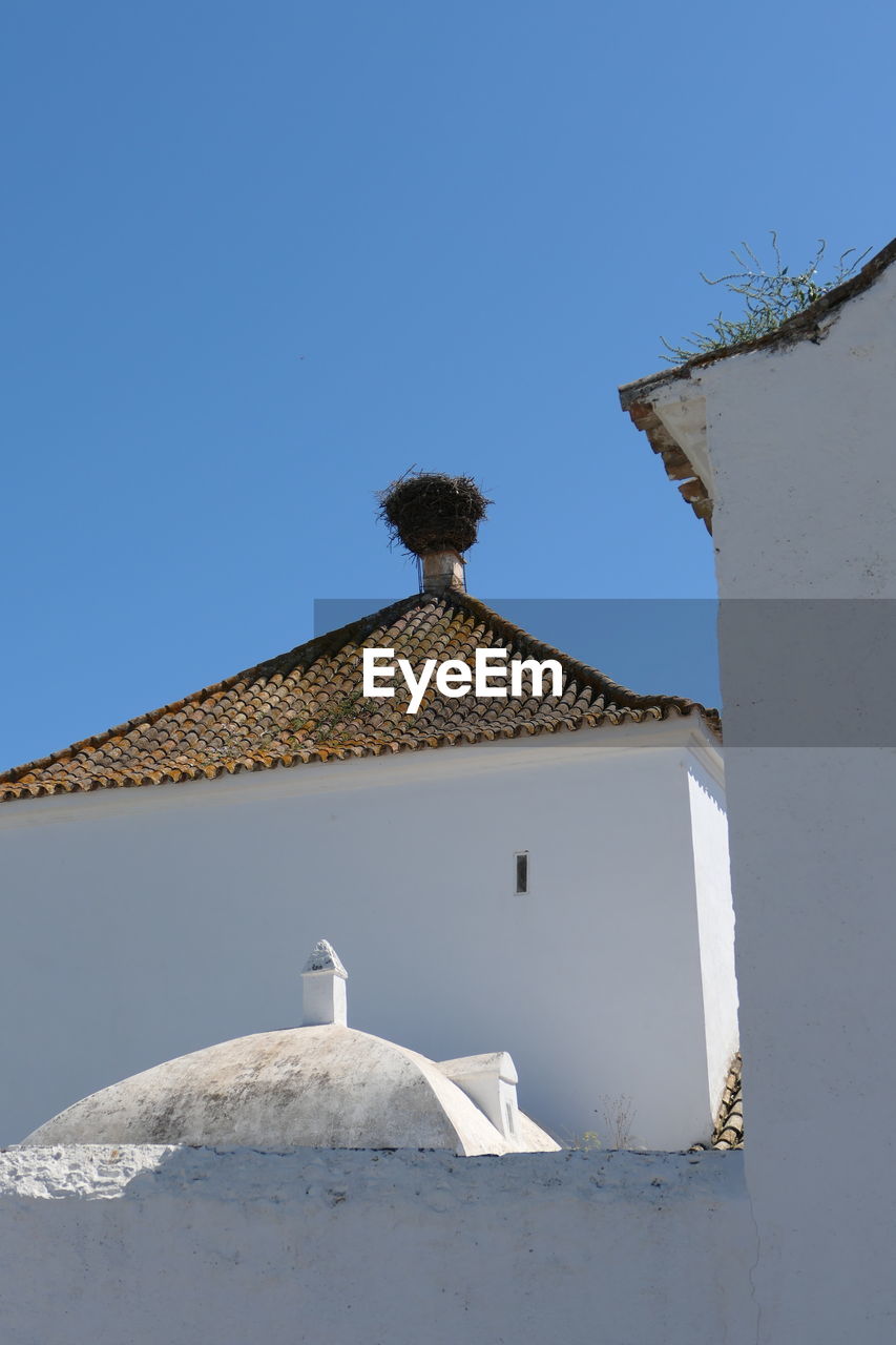 Parroquia del salvador in la villa, ayamonte stork nest on historic andalusian church 