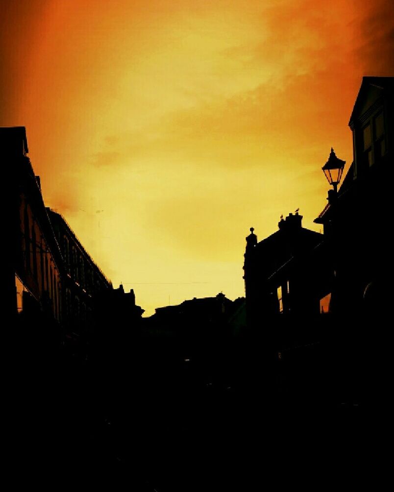 LOW ANGLE VIEW OF BUILDINGS AGAINST SKY AT SUNSET