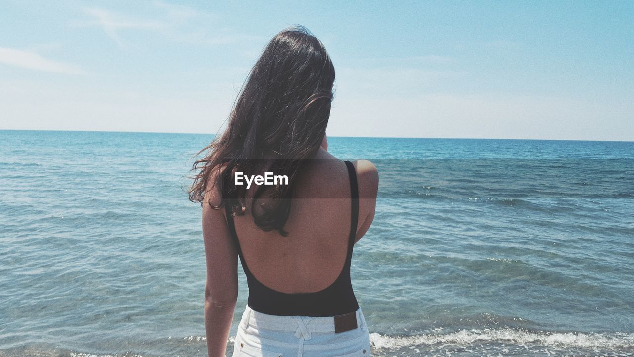 Rear view of woman looking at sea