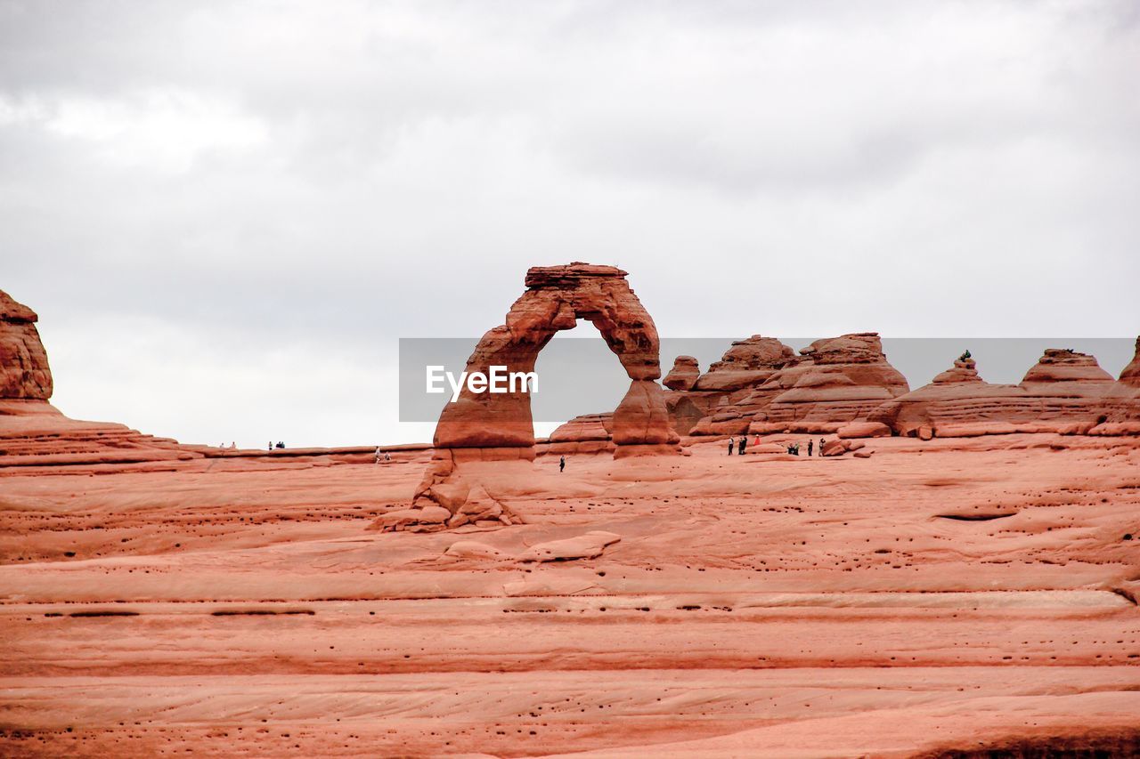 Rock formation on landscape against sky