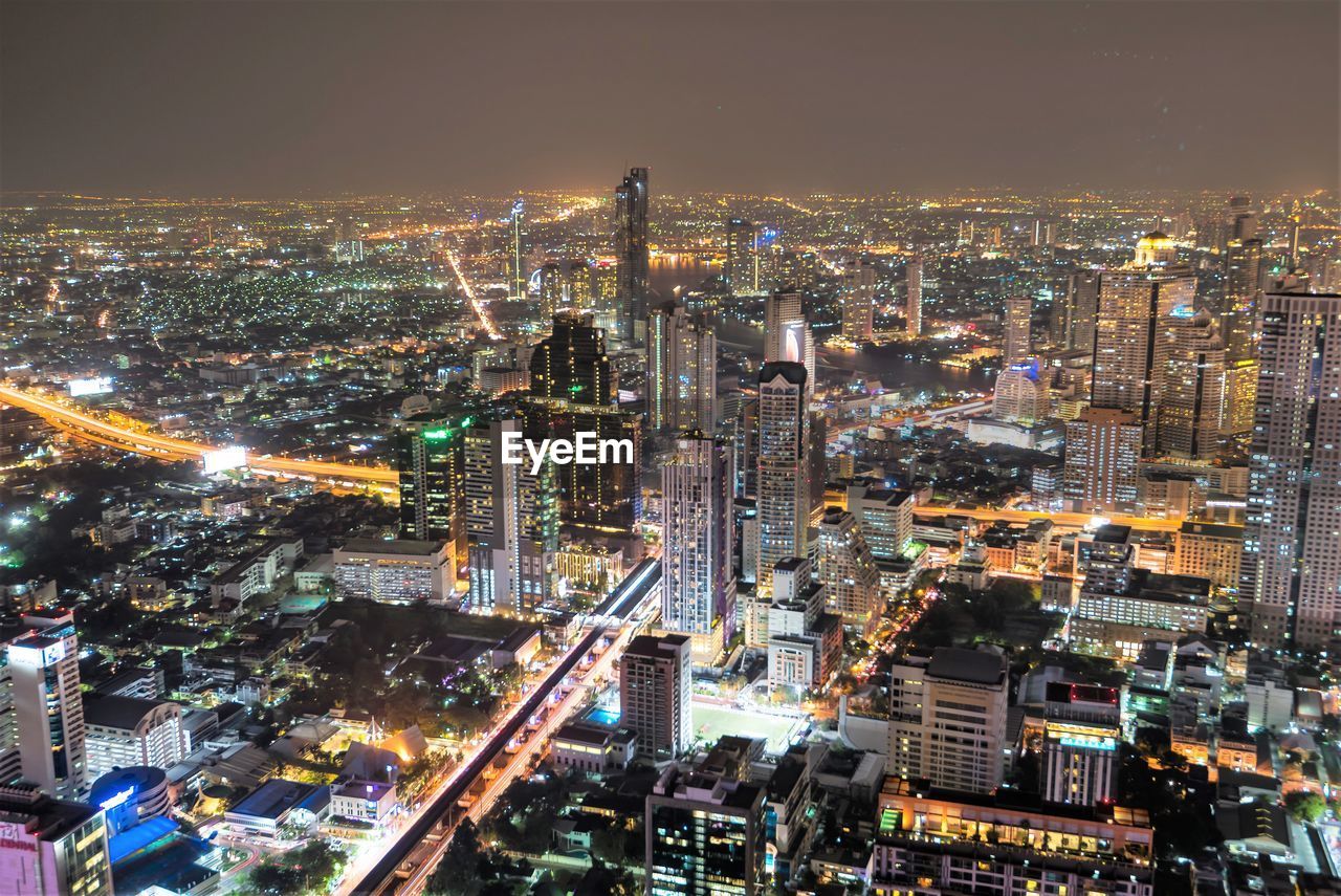 Aerial view of illuminated city buildings at dusk