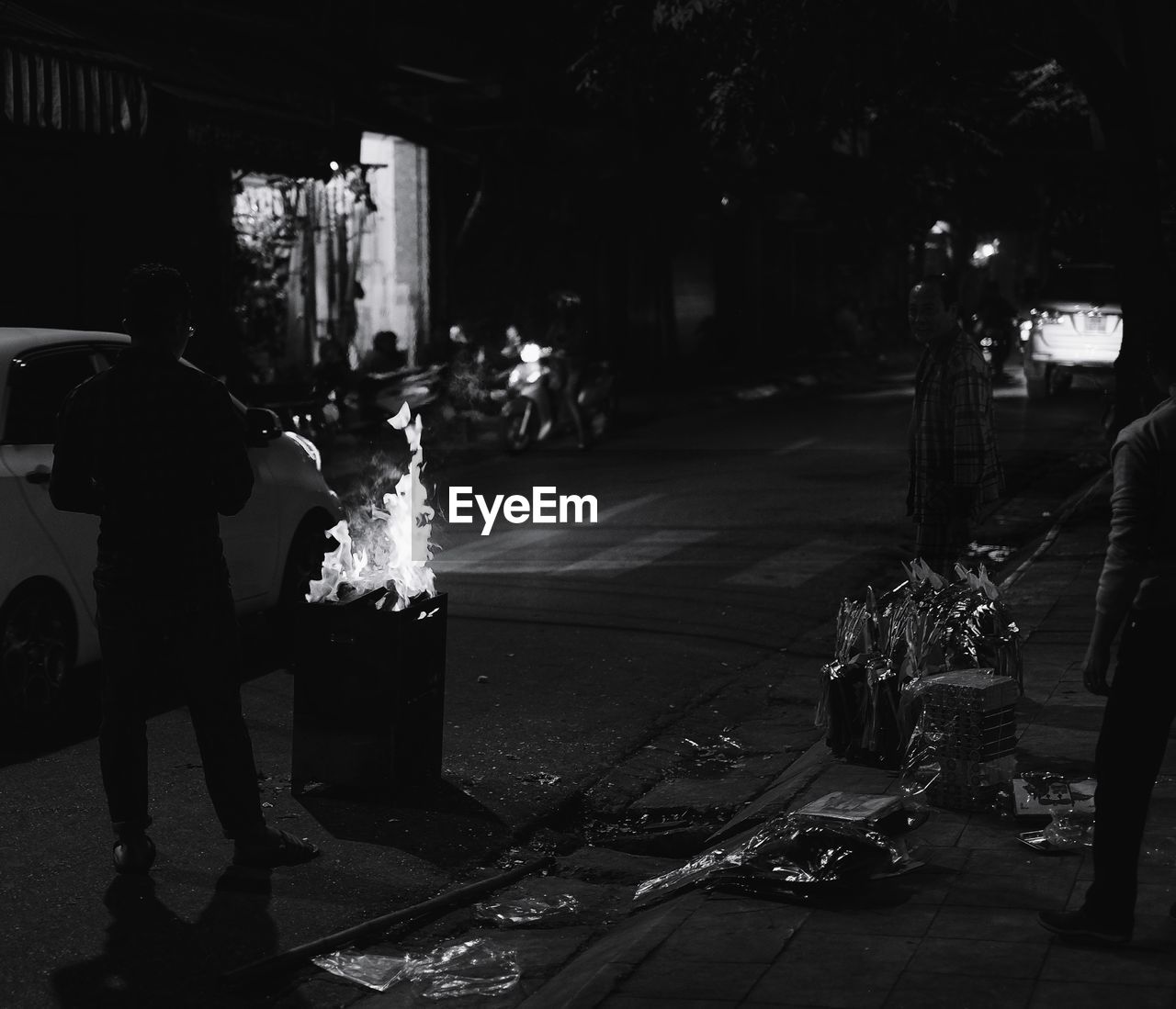 MAN ON ILLUMINATED STREET AT NIGHT