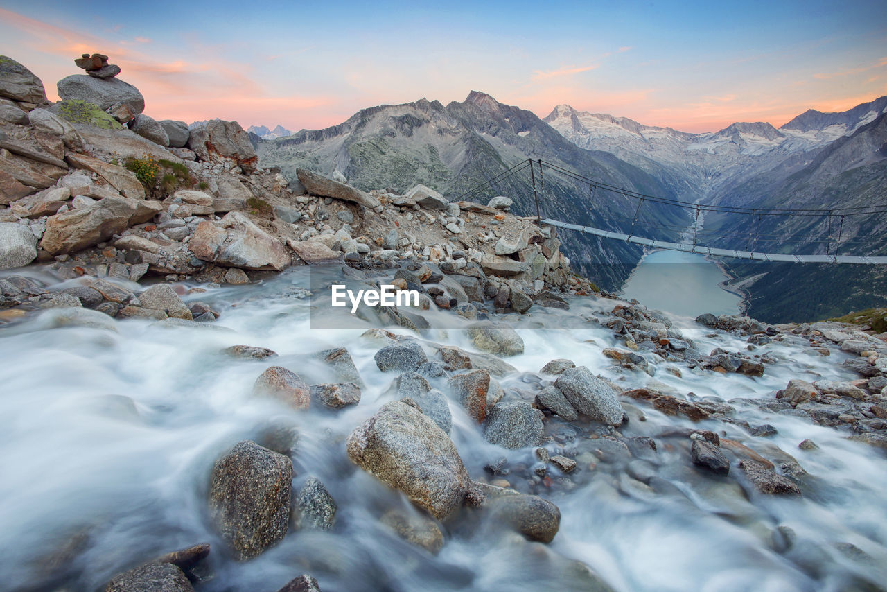 scenic view of river amidst snowcapped mountains against sky