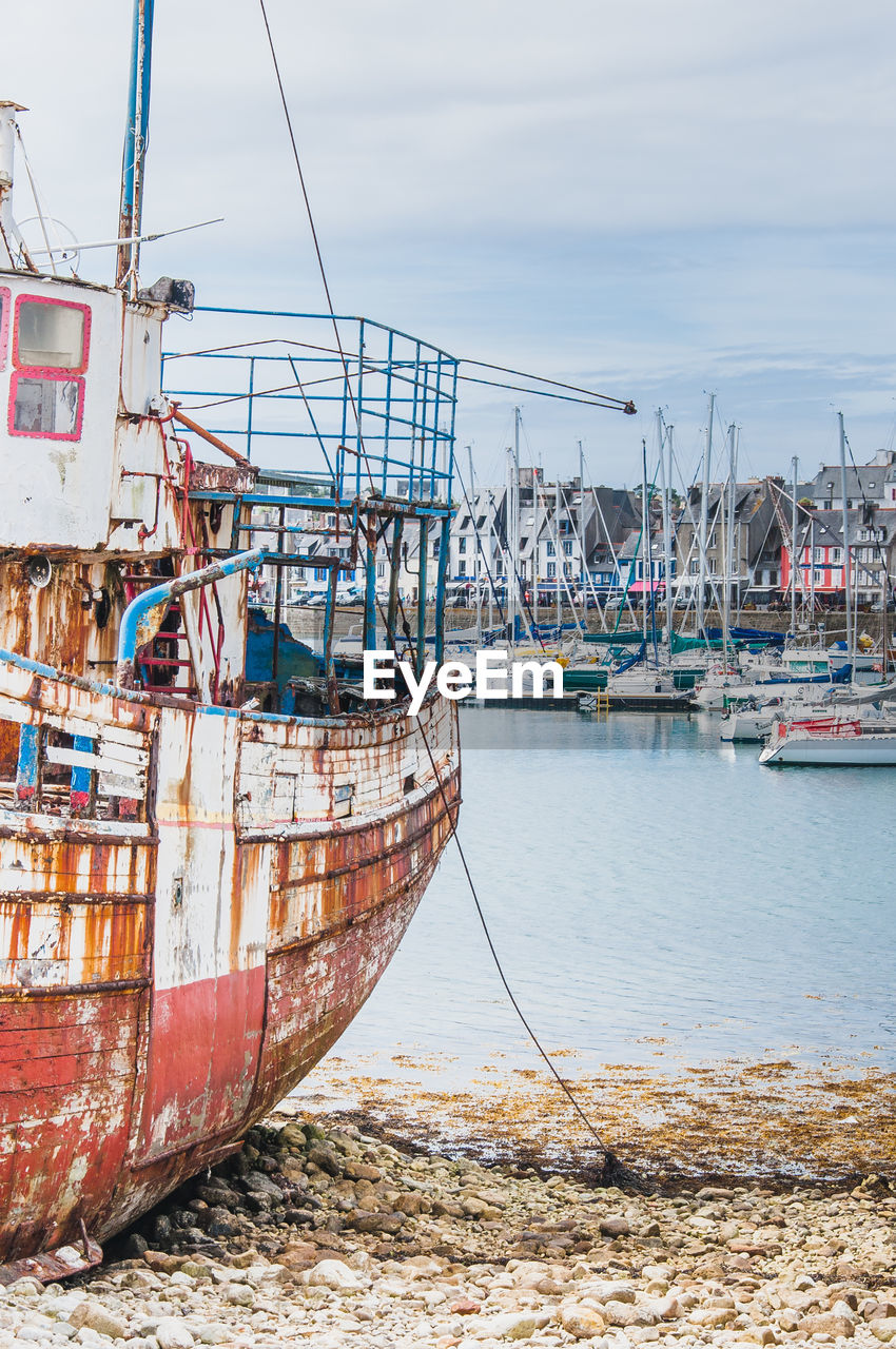 BOATS MOORED AT HARBOR