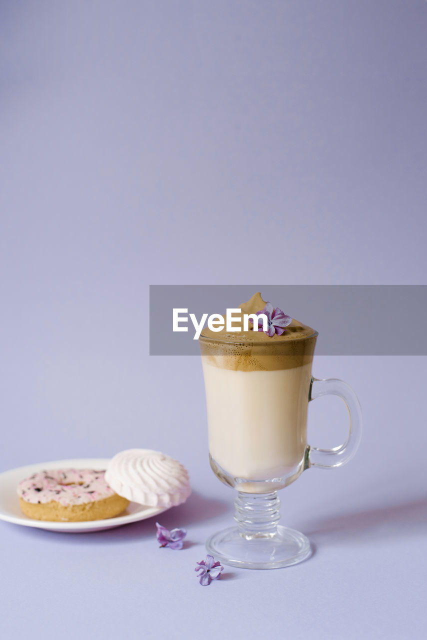 food and drink, studio shot, food, dessert, drink, sweet food, refreshment, sweet, colored background, dairy, indoors, copy space, freshness, no people, ice cream, saucer, still life, blue background, cream, chocolate, cup, crockery, coffee, coffee cup, milk, fruit, glass, blue