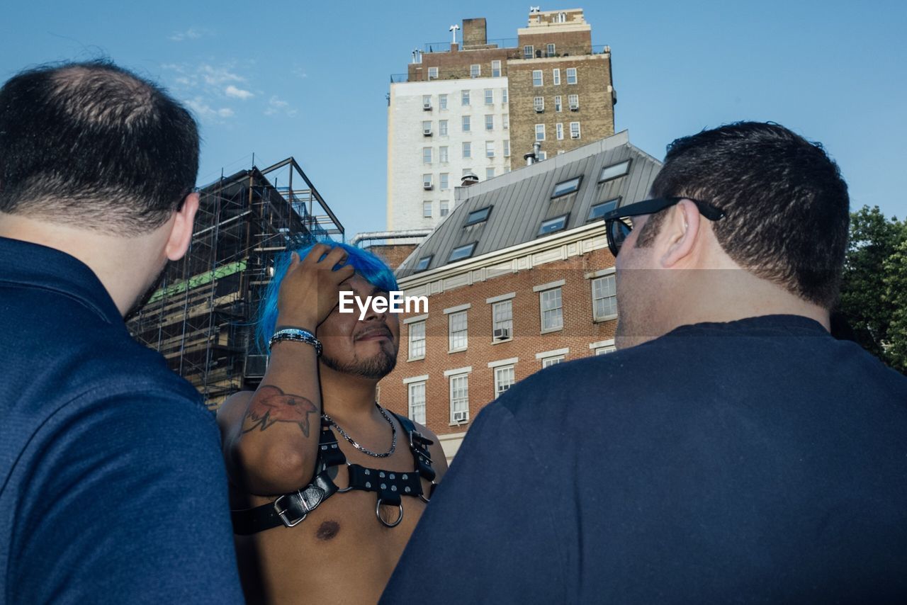 REAR VIEW OF PEOPLE AGAINST BUILDINGS