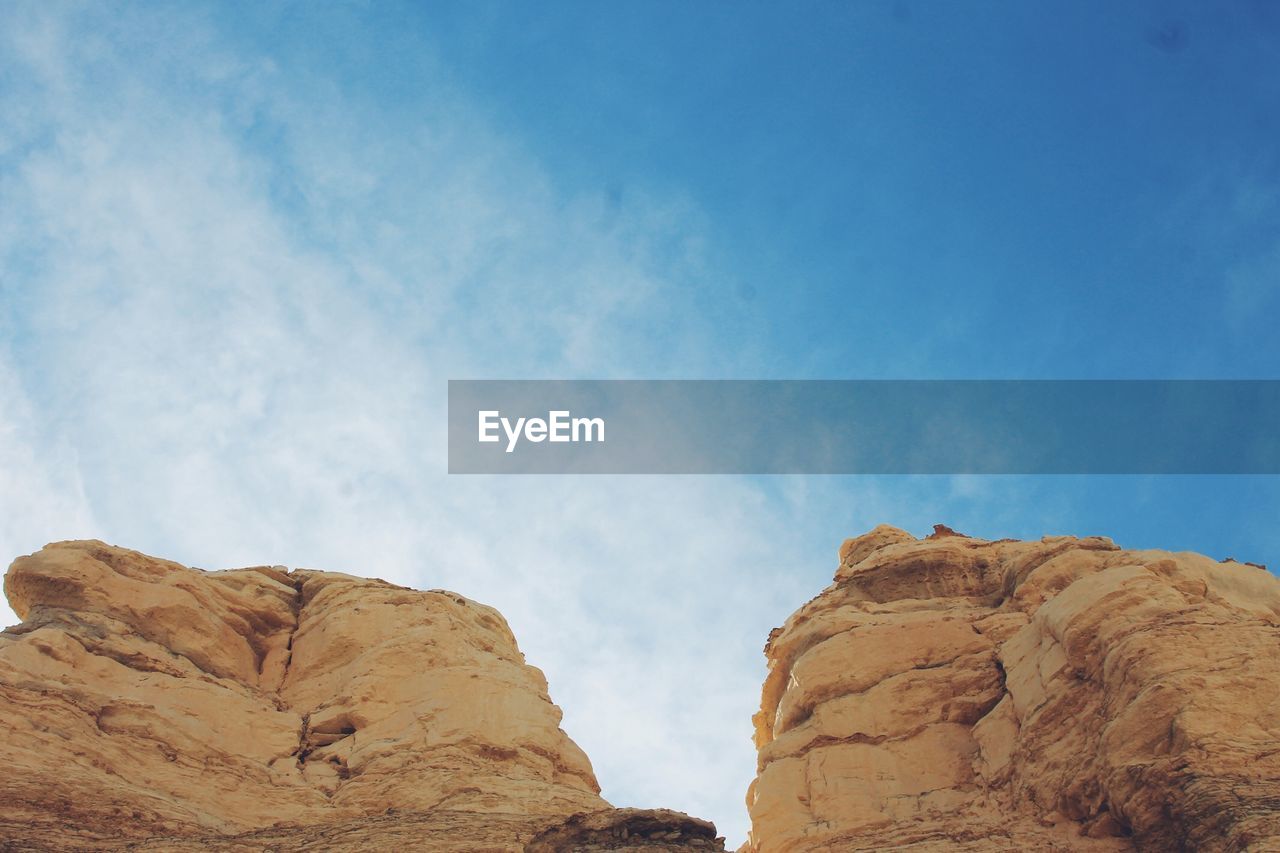 Low angle view of rock formation against sky