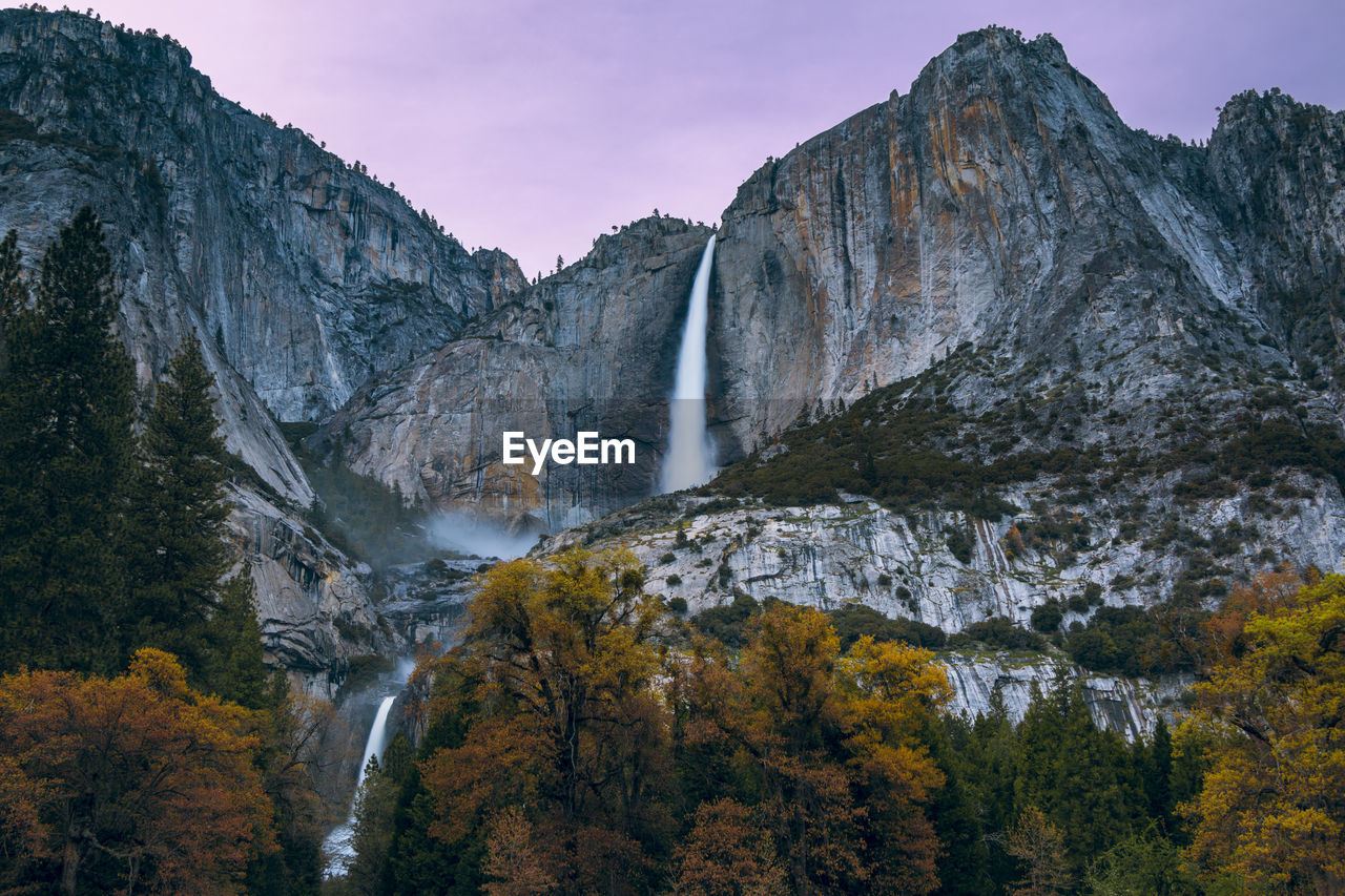 Scenic view of waterfall against sky