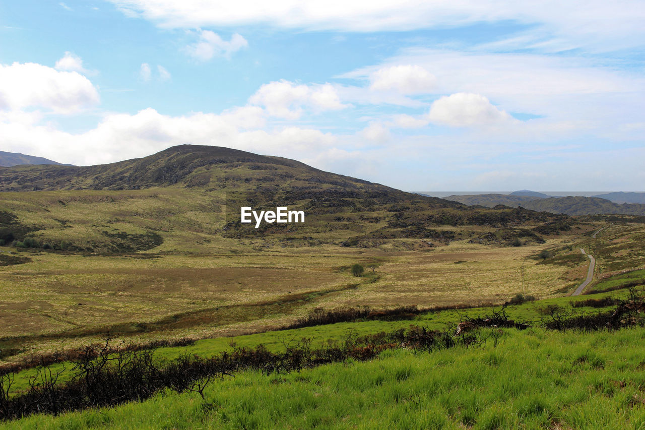 SCENIC VIEW OF LANDSCAPE AND MOUNTAINS AGAINST SKY