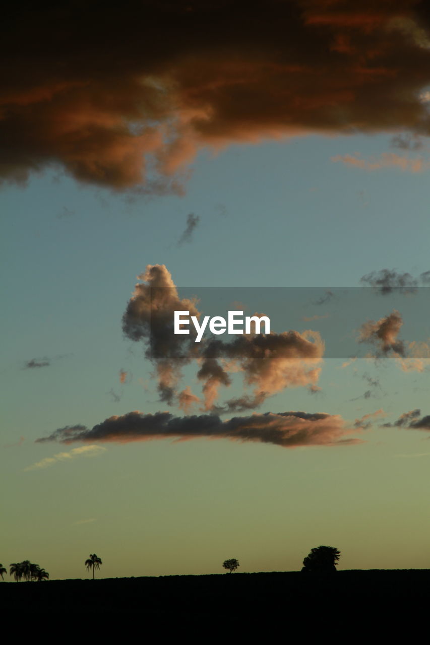 LOW ANGLE VIEW OF SILHOUETTE LANDSCAPE AGAINST SKY DURING SUNSET