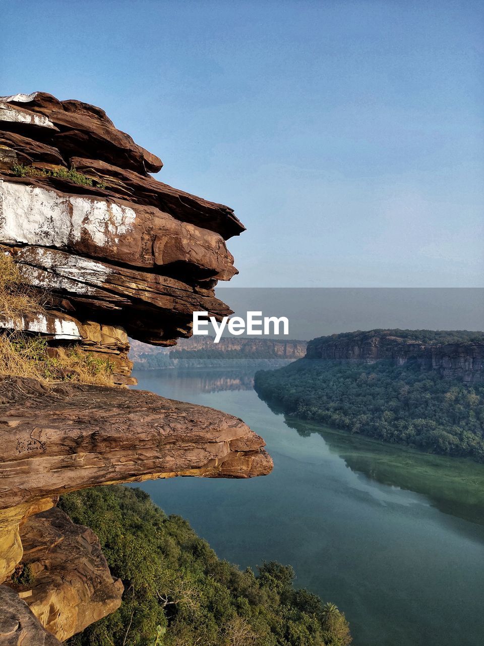 Rock formations by sea against sky