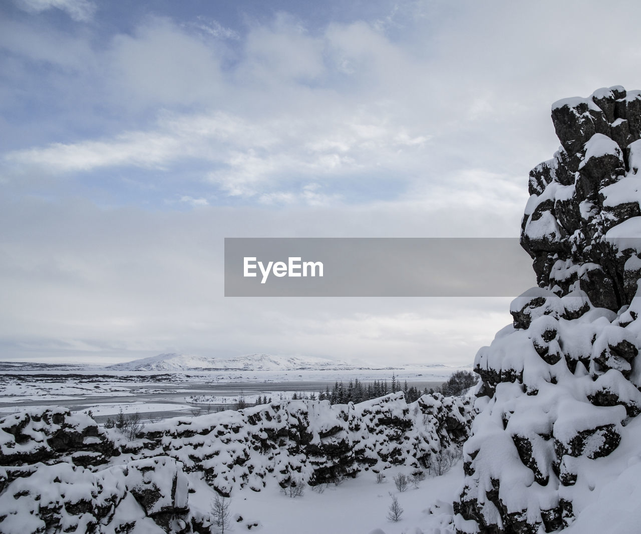 Scenic view of frozen landscape against sky