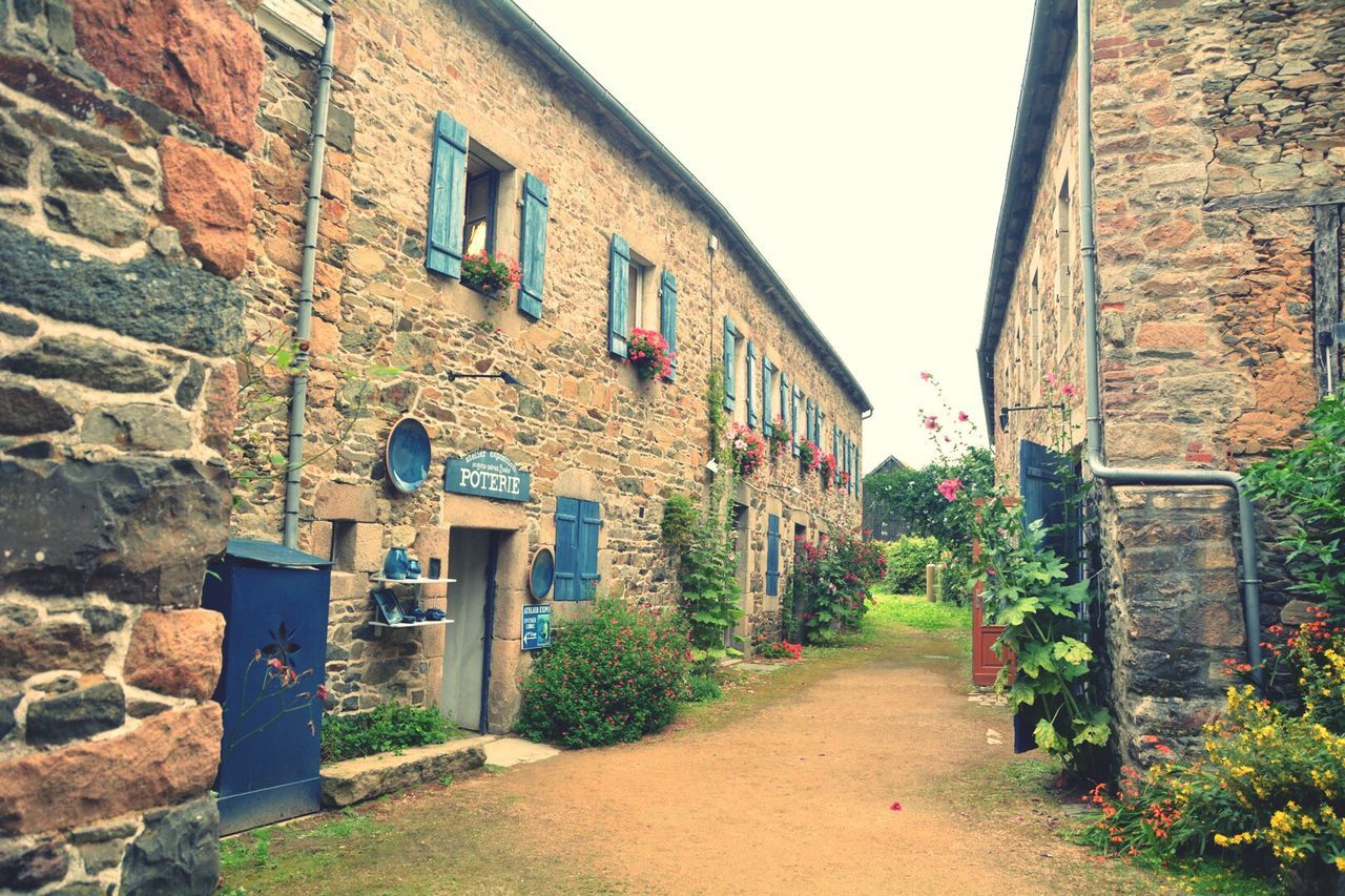 NARROW ALLEY WITH BUILDINGS IN BACKGROUND