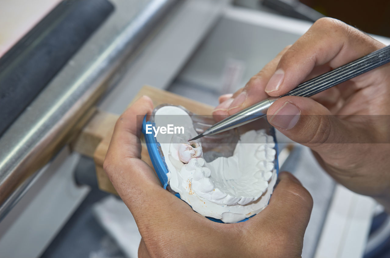 MIDSECTION OF MAN HOLDING ICE CREAM IN KITCHEN
