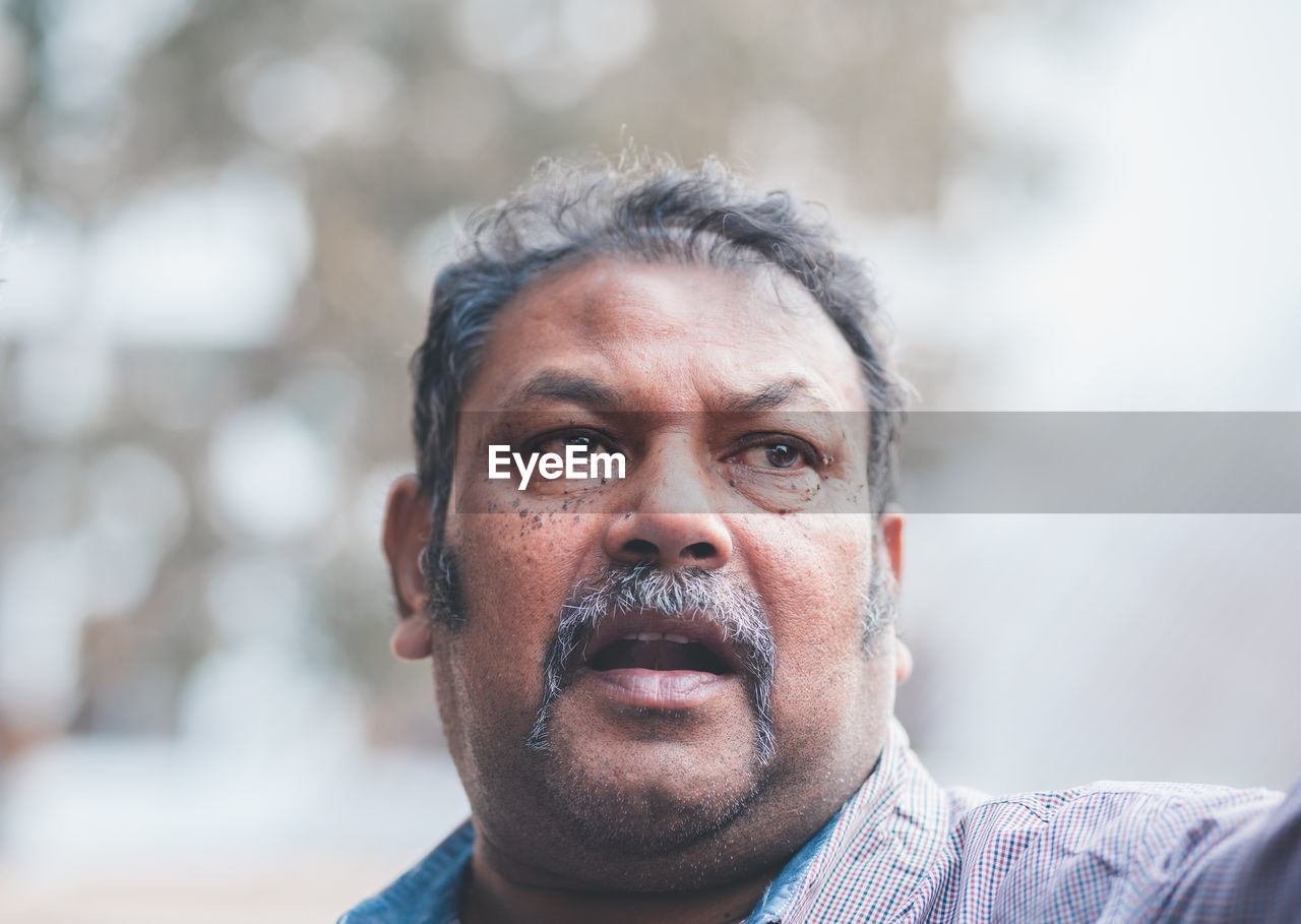 Close-up of mature man looking away