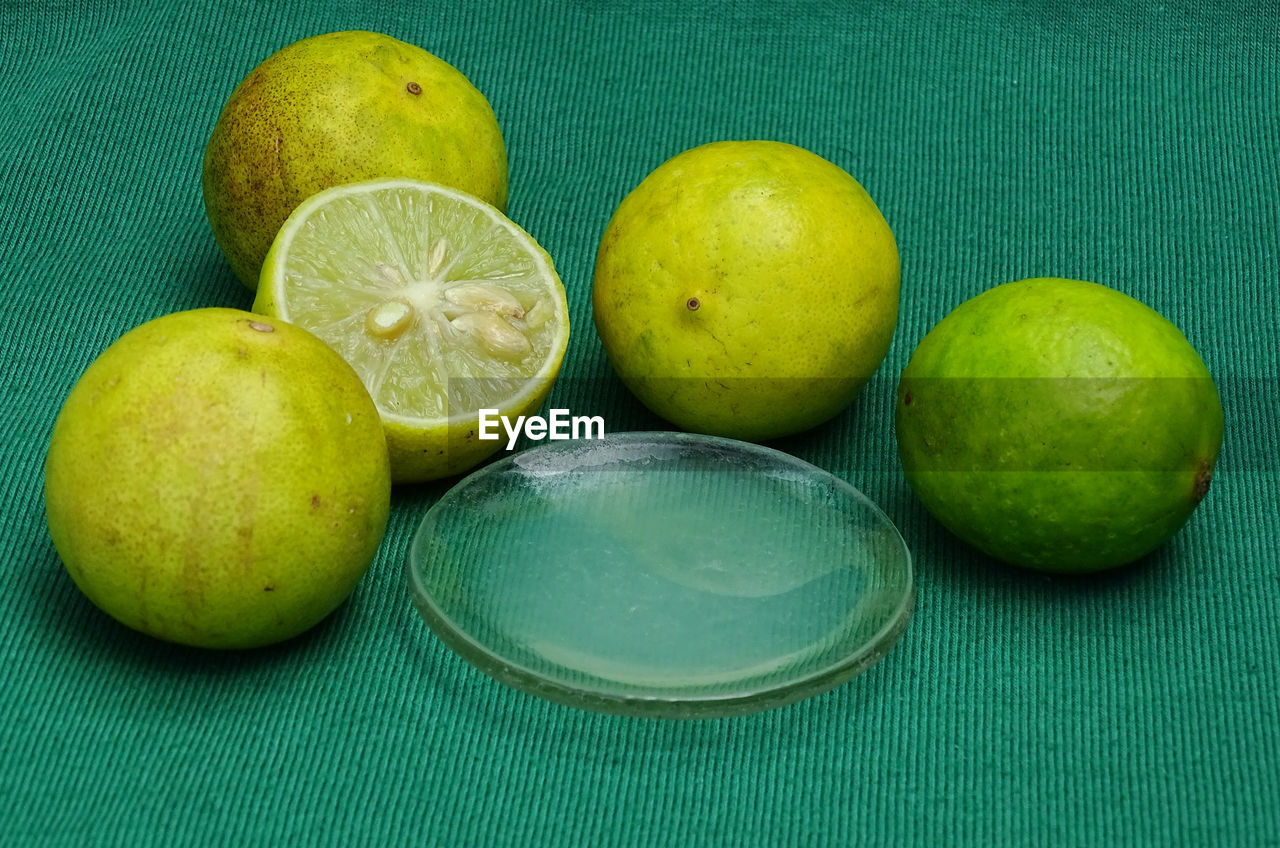 HIGH ANGLE VIEW OF FRUITS IN GREEN BACKGROUND