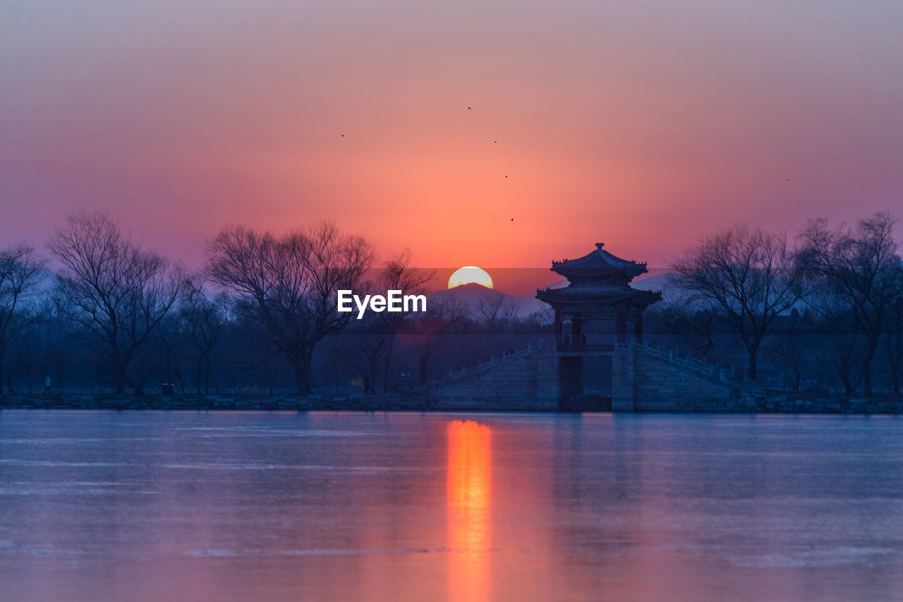 Scenic view of lake at sunset