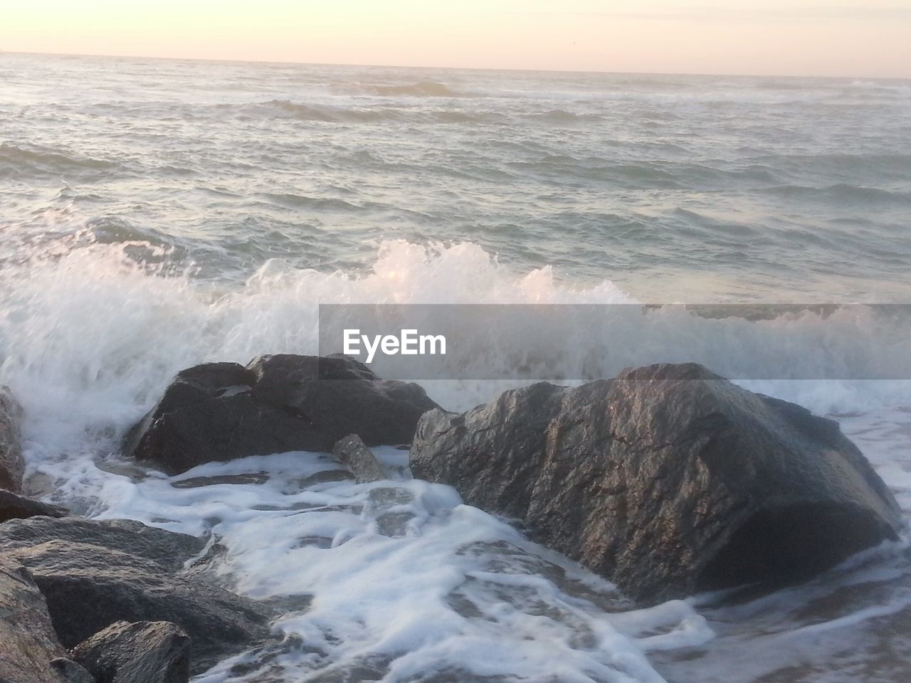 WAVES SPLASHING ON ROCKS AT SHORE