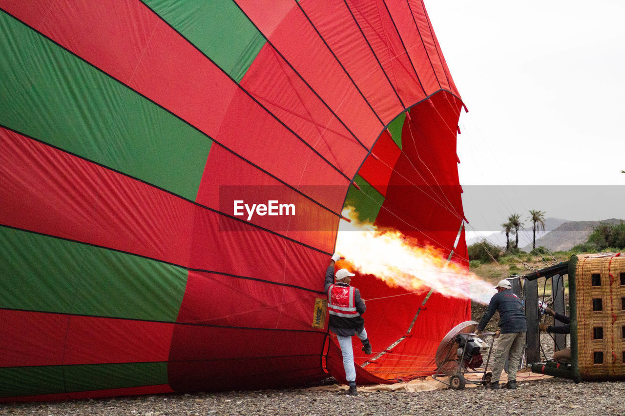 VIEW OF HOT AIR BALLOON AGAINST RED FIRE