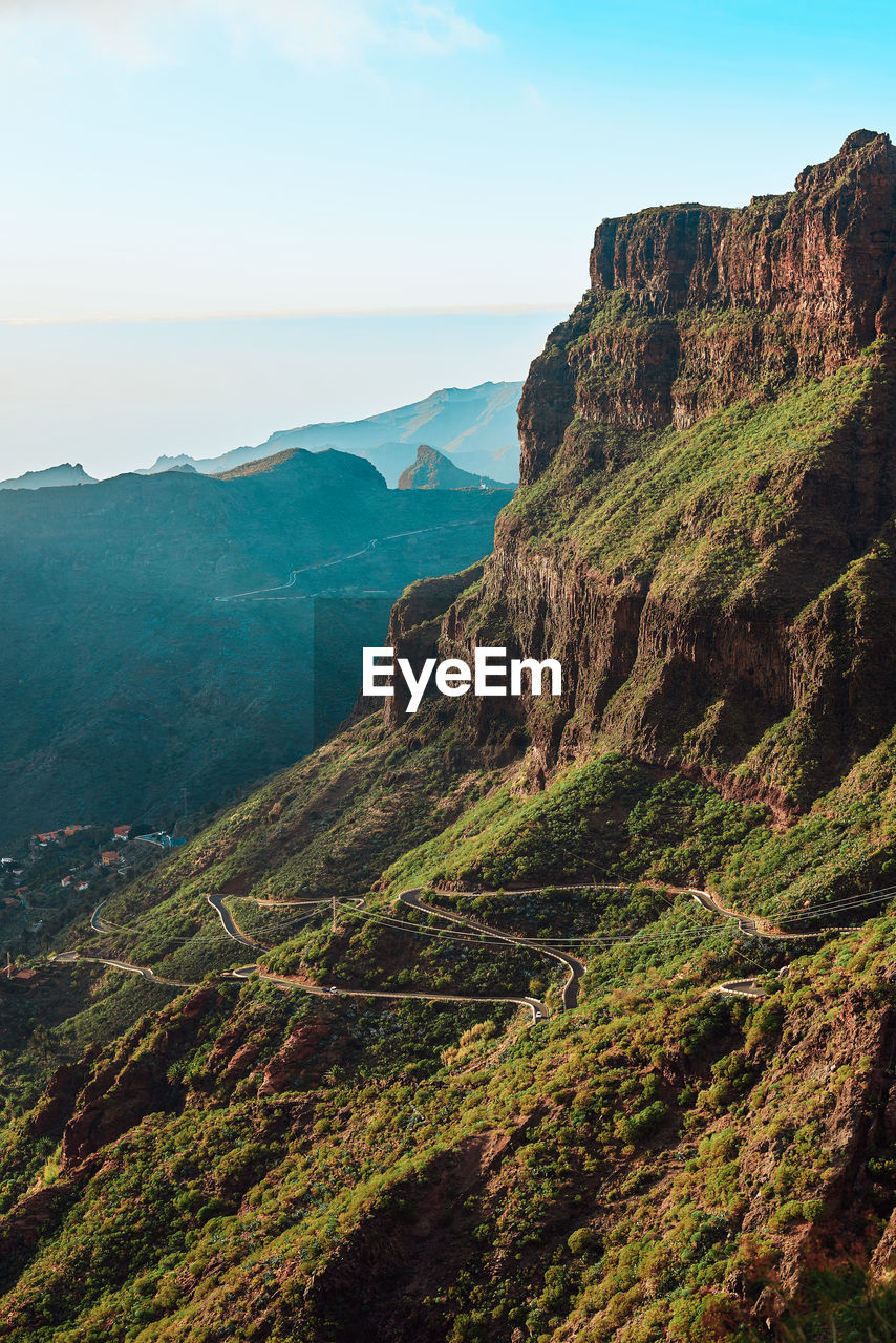 Scenic view of mountains against clear sky during sunny day