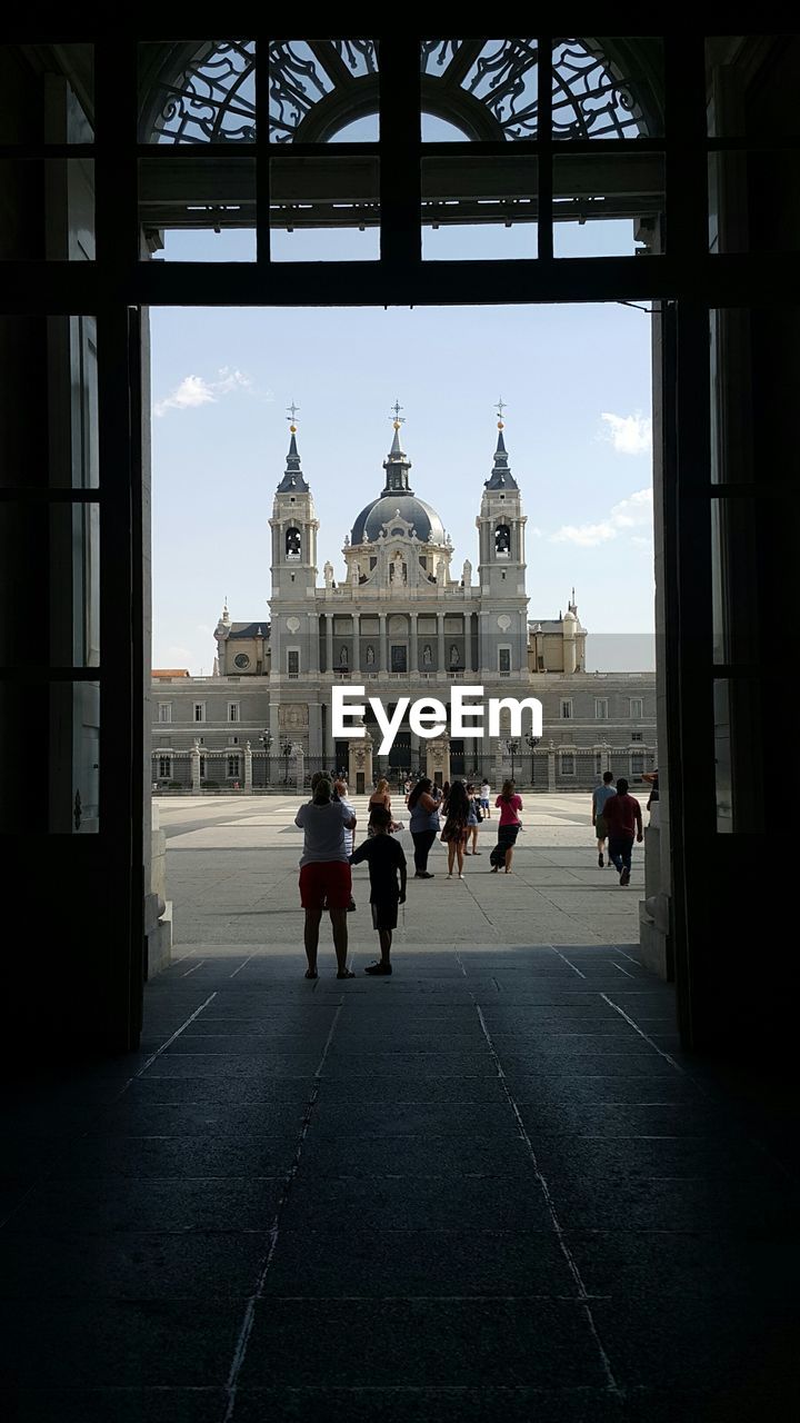 People walking in front of building