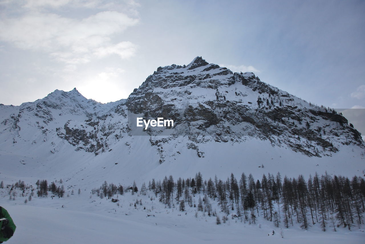 Scenic view of snow covered mountains against sky