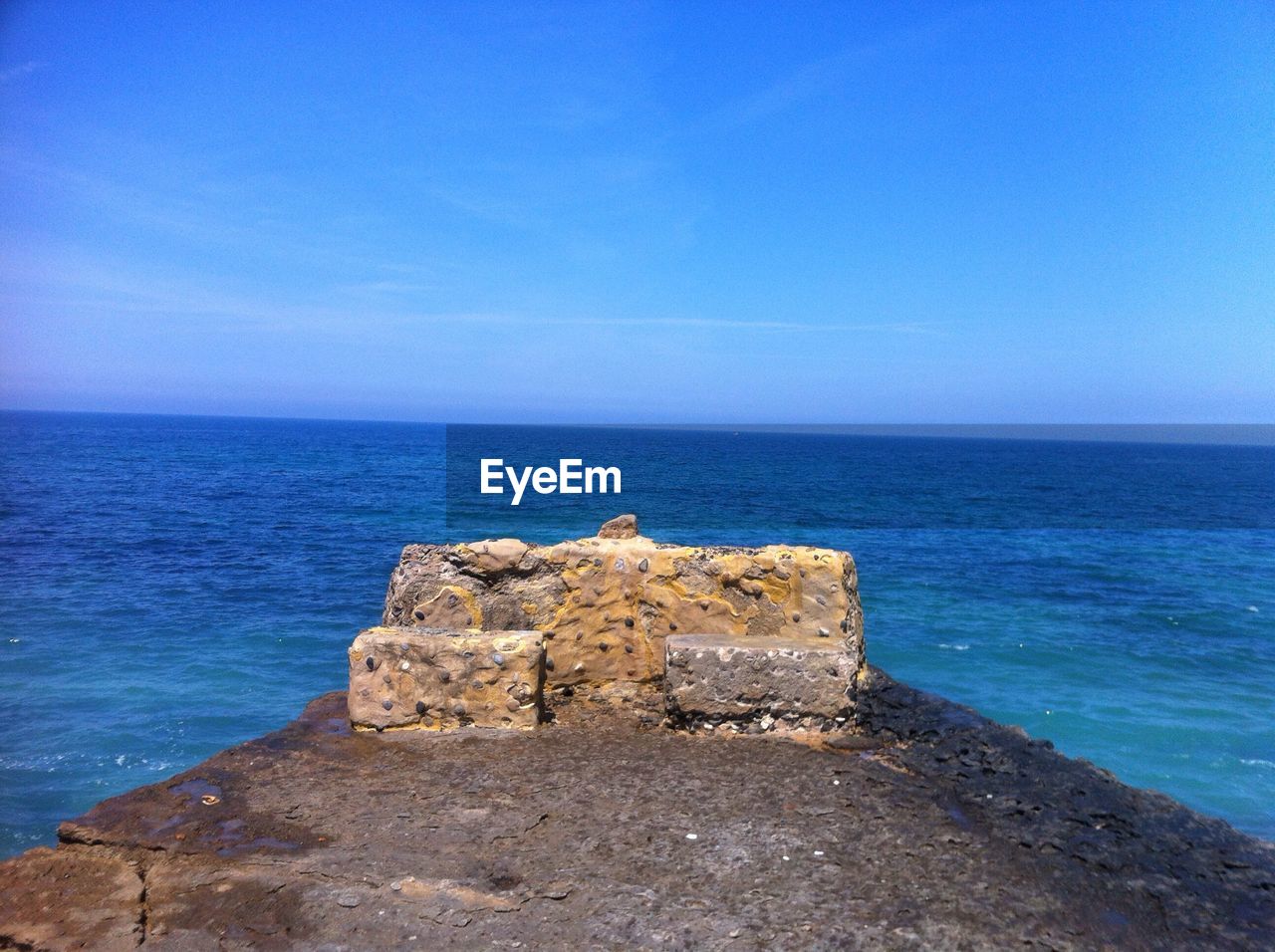 Scenic view of sea against blue sky