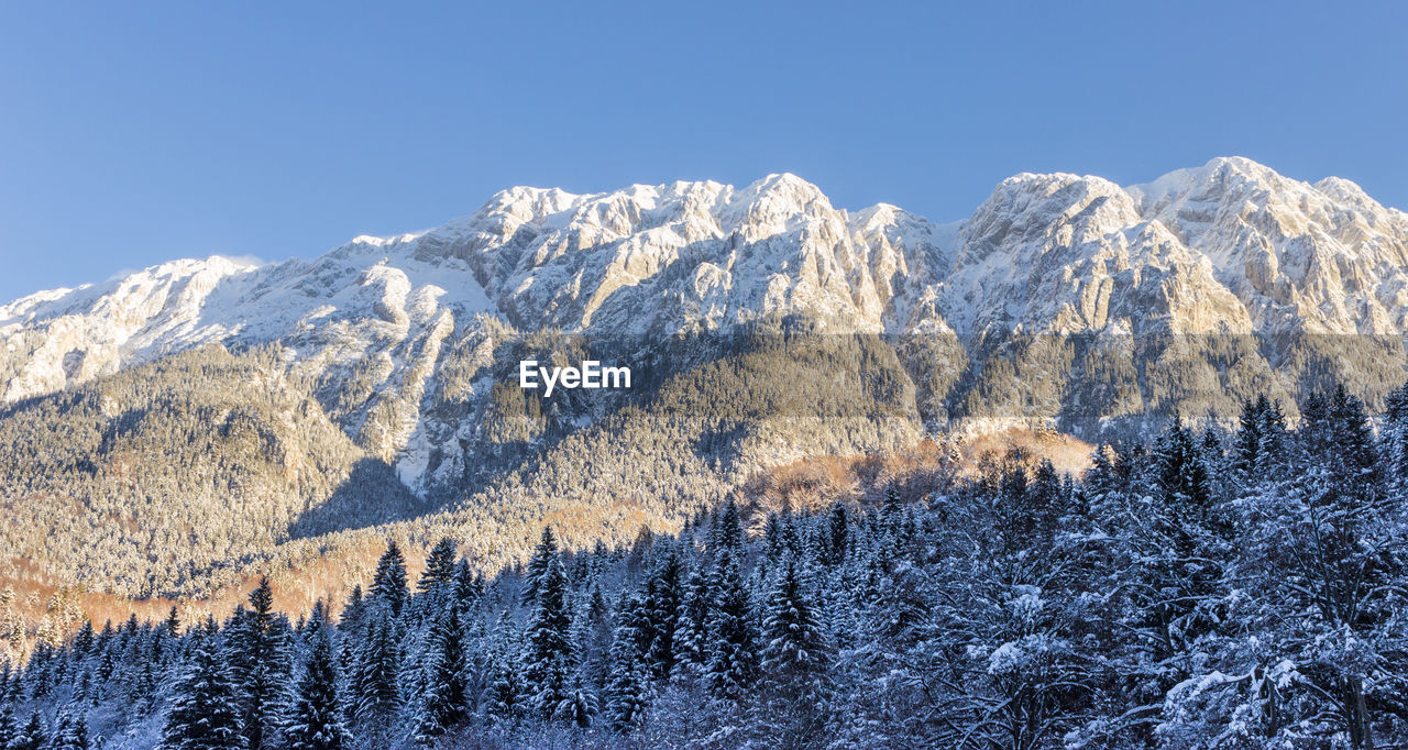 Scenic view of snowcapped mountains against clear sky