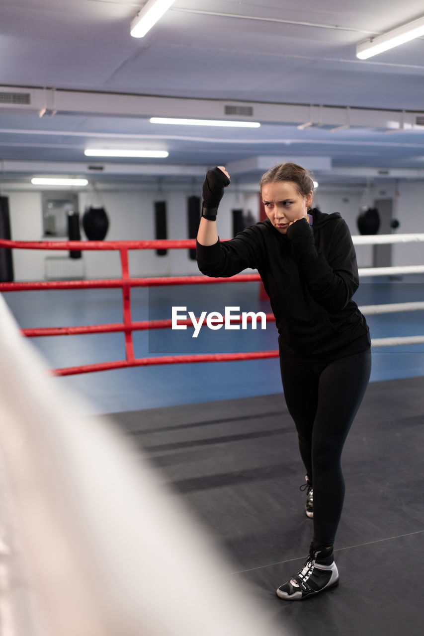 Angry boxer practicing uppercuts during workout