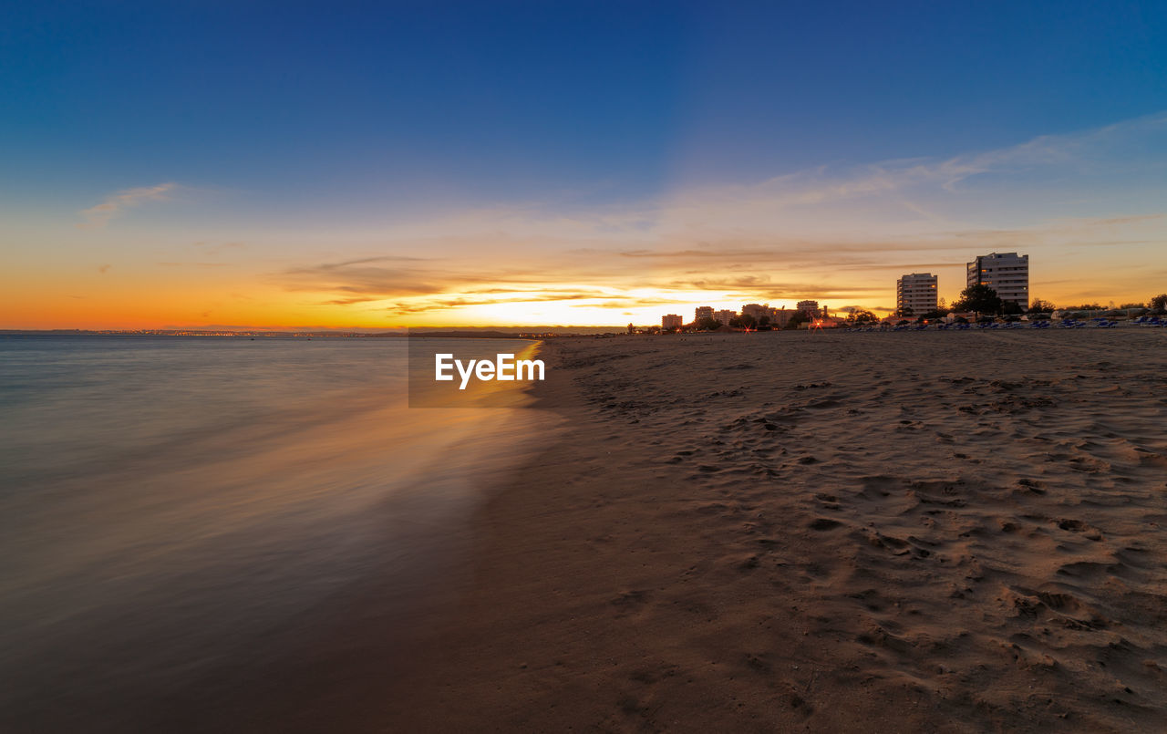 Scenic view of beach against sky during sunset