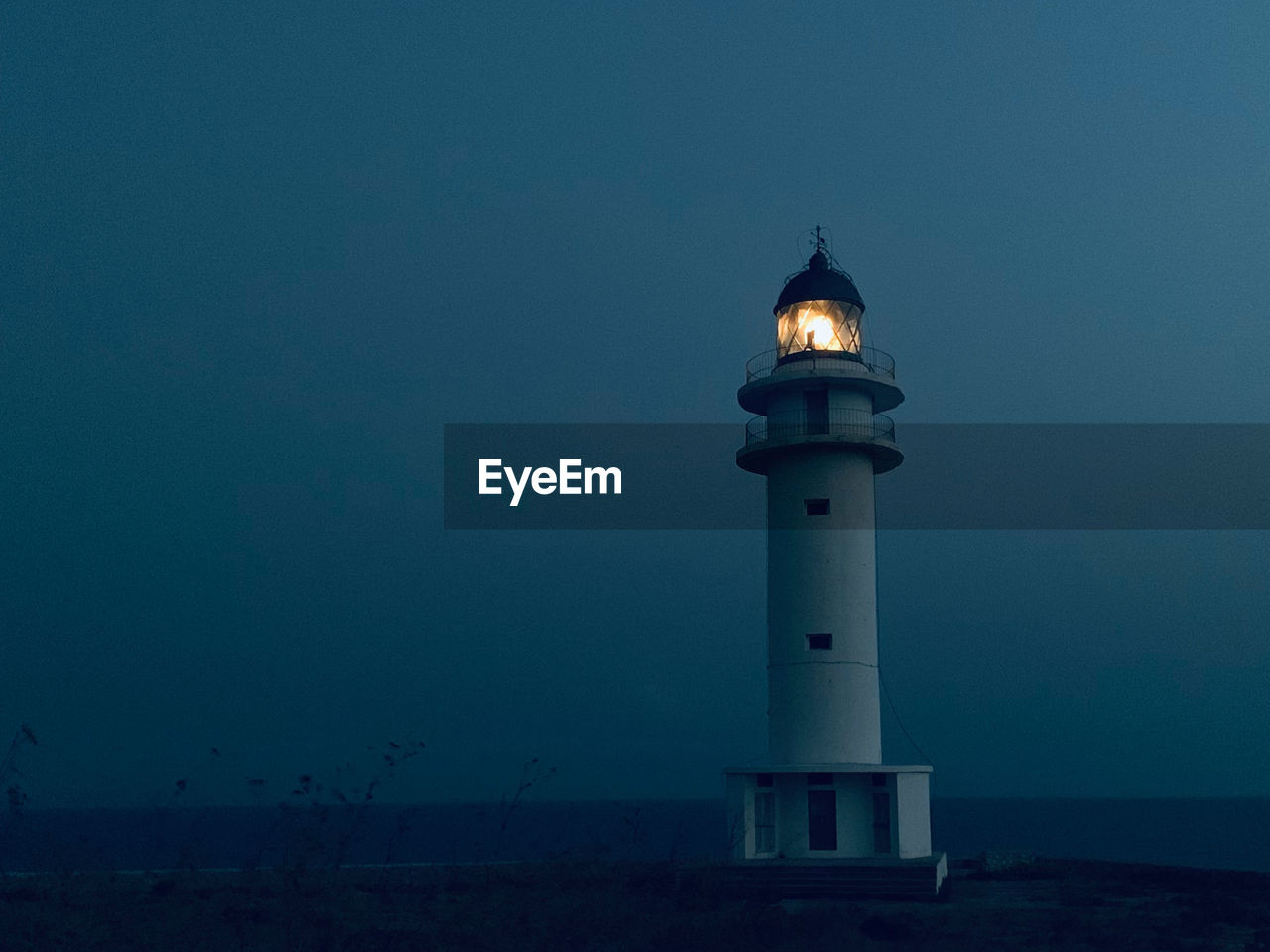 Lighthouse against sky at night