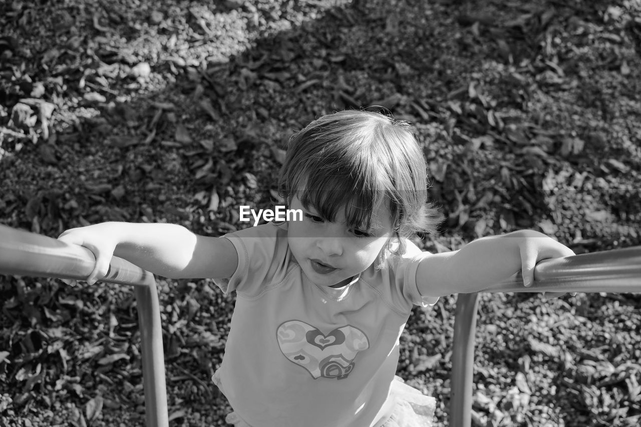 High angle view of girl holding railing