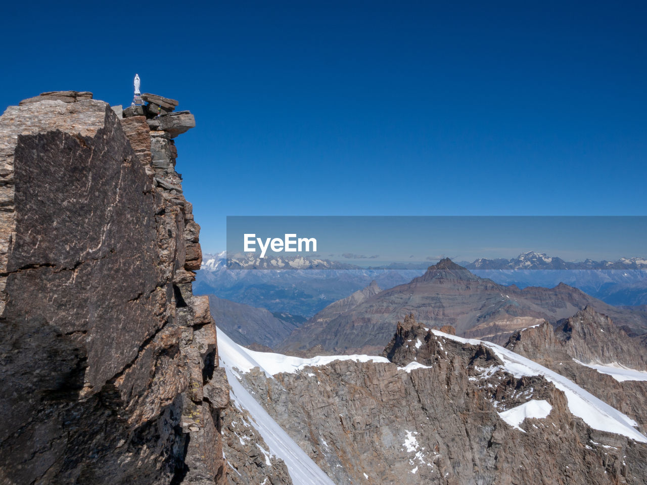 Scenic view of mountains against clear blue sky