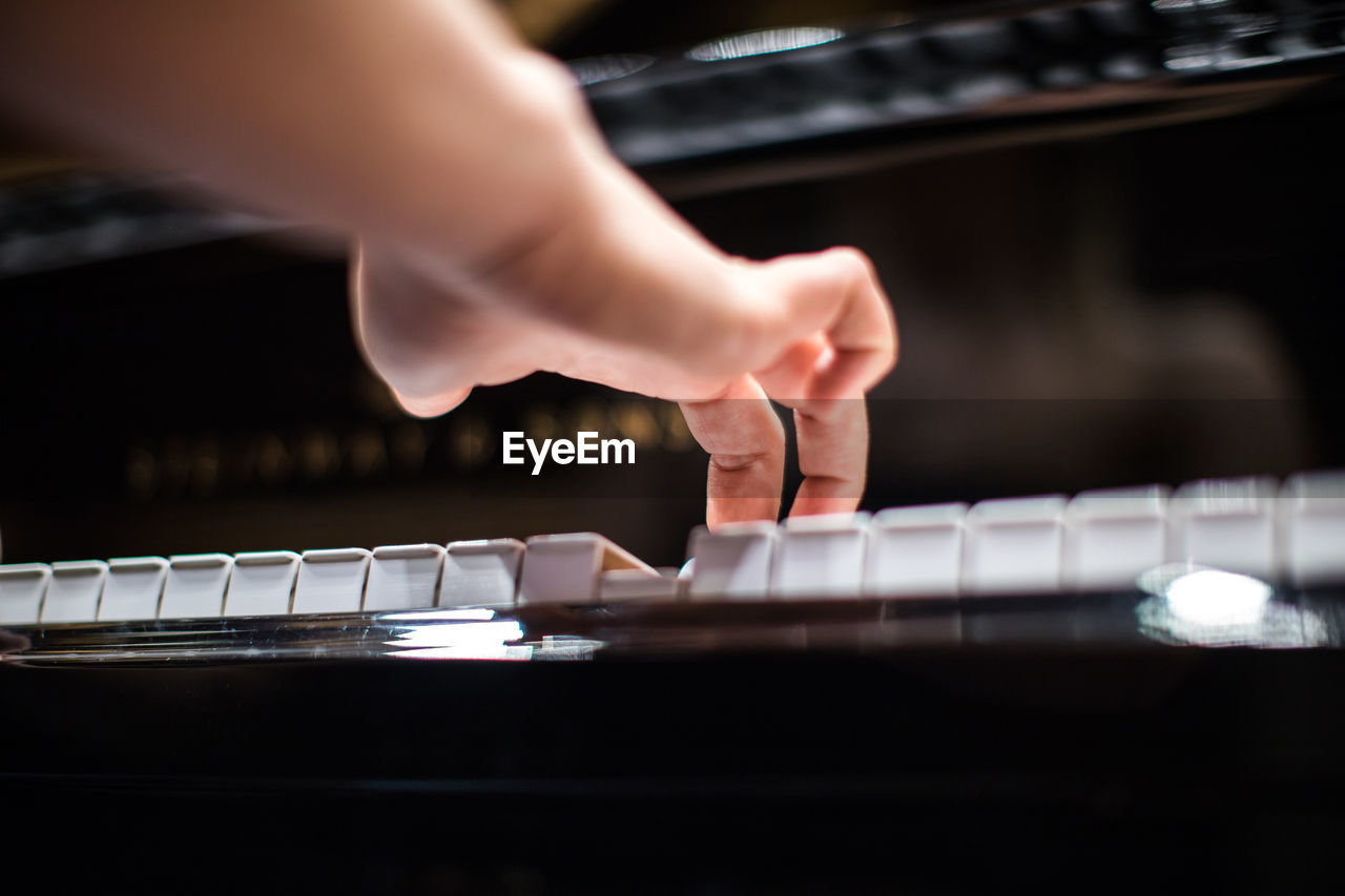 Midsection of person playing piano