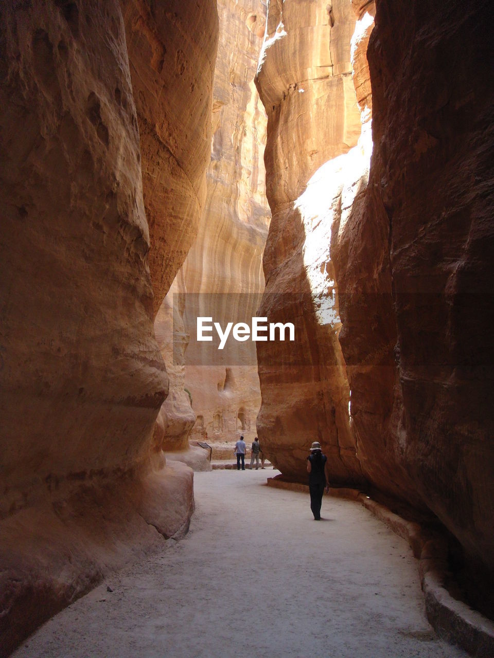 Rear view of man walking on rock