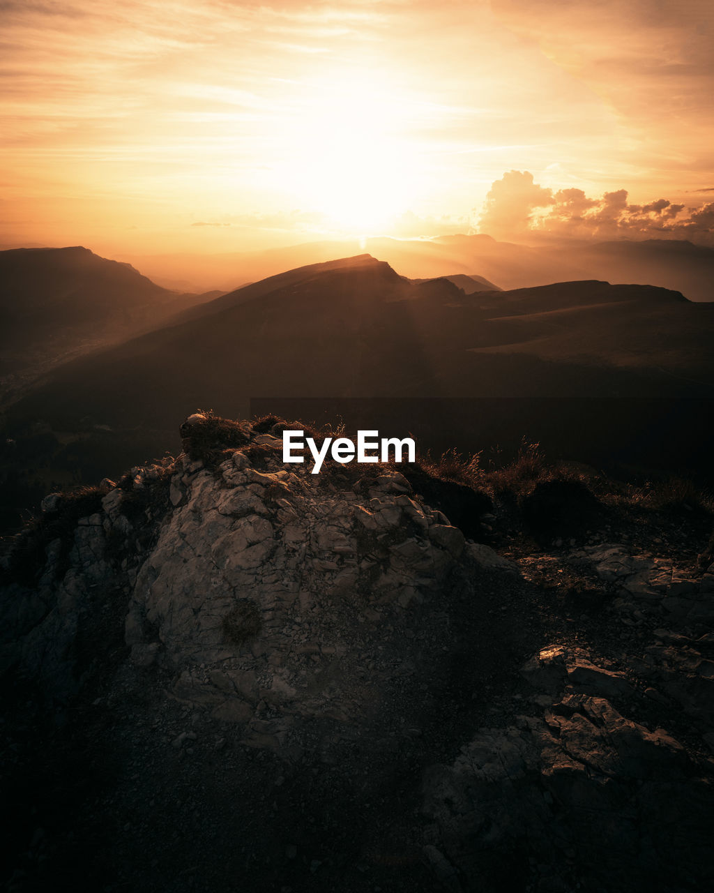 AERIAL VIEW OF MOUNTAIN AGAINST SKY DURING SUNSET