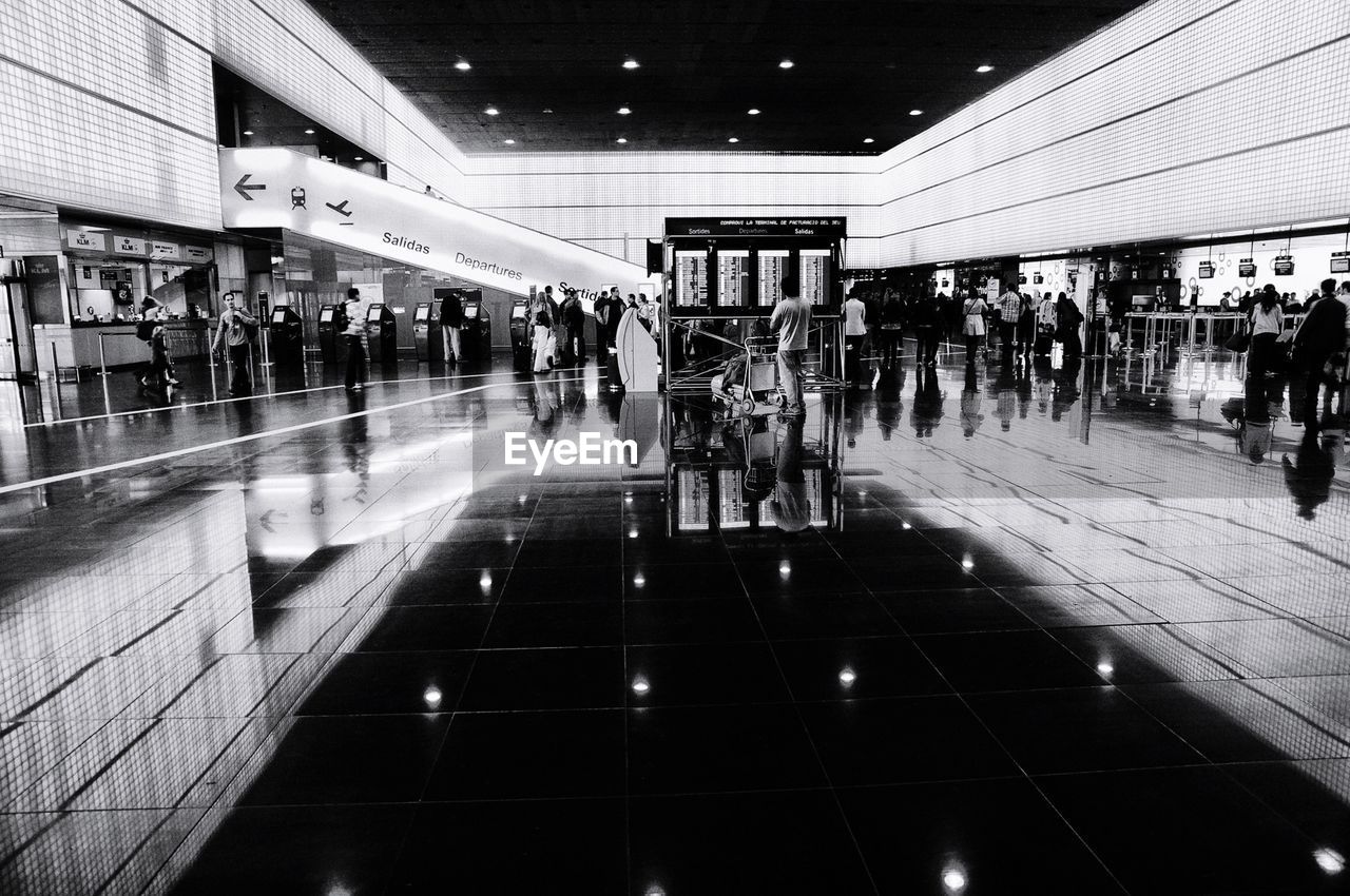 Group of people walking in airport lobby