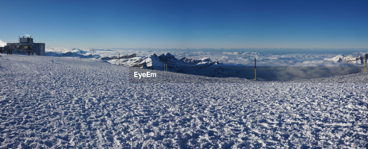 Panoramic shot of frozen landscape against blue sky