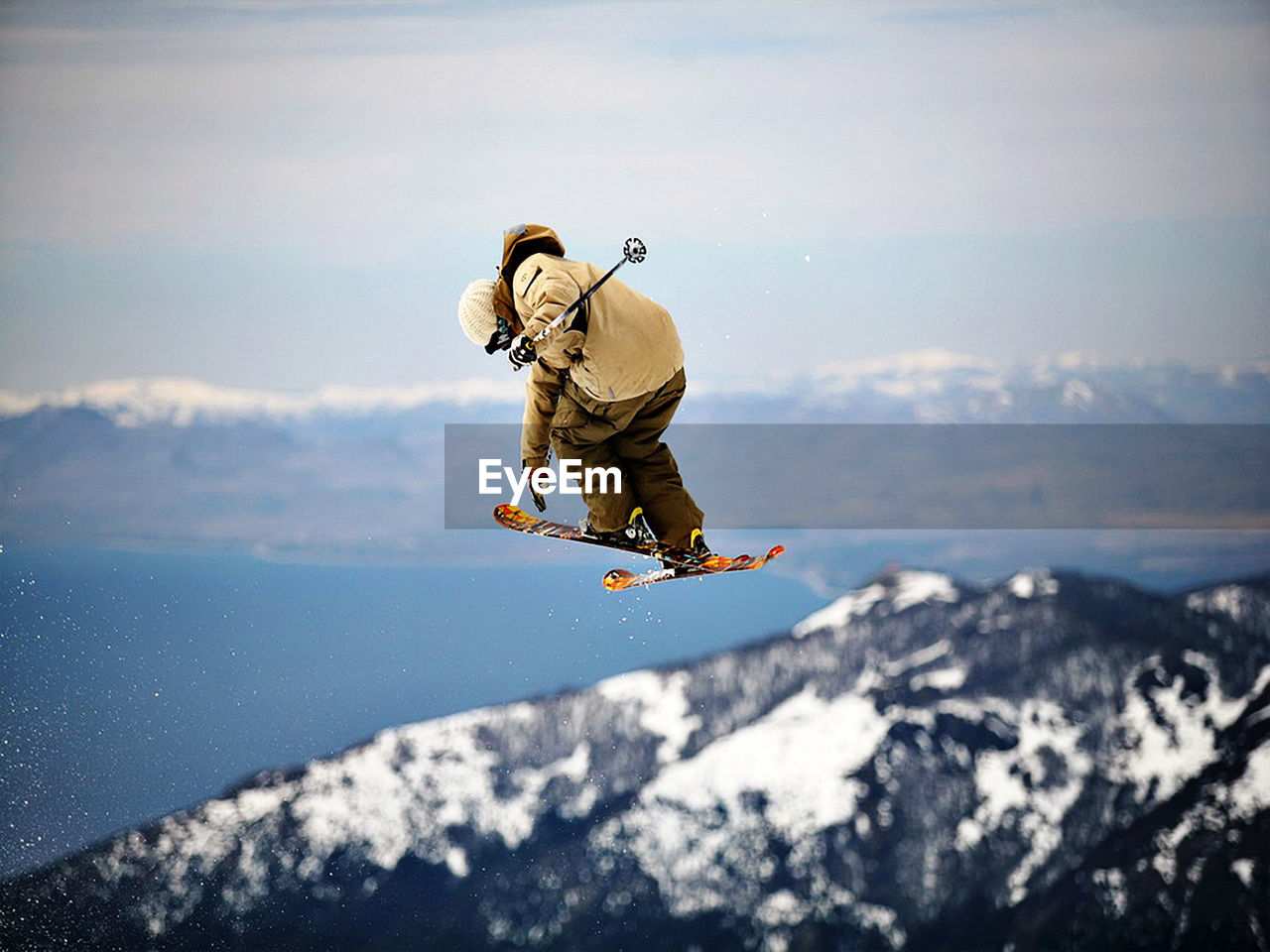 Man jumping in mountain against sky