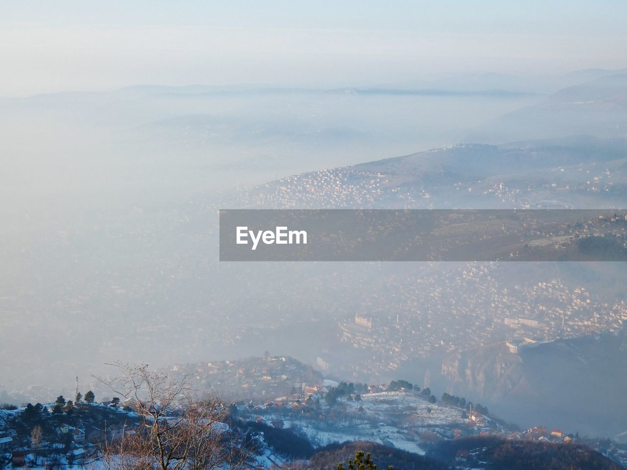 Aerial view of city and mountains against sky