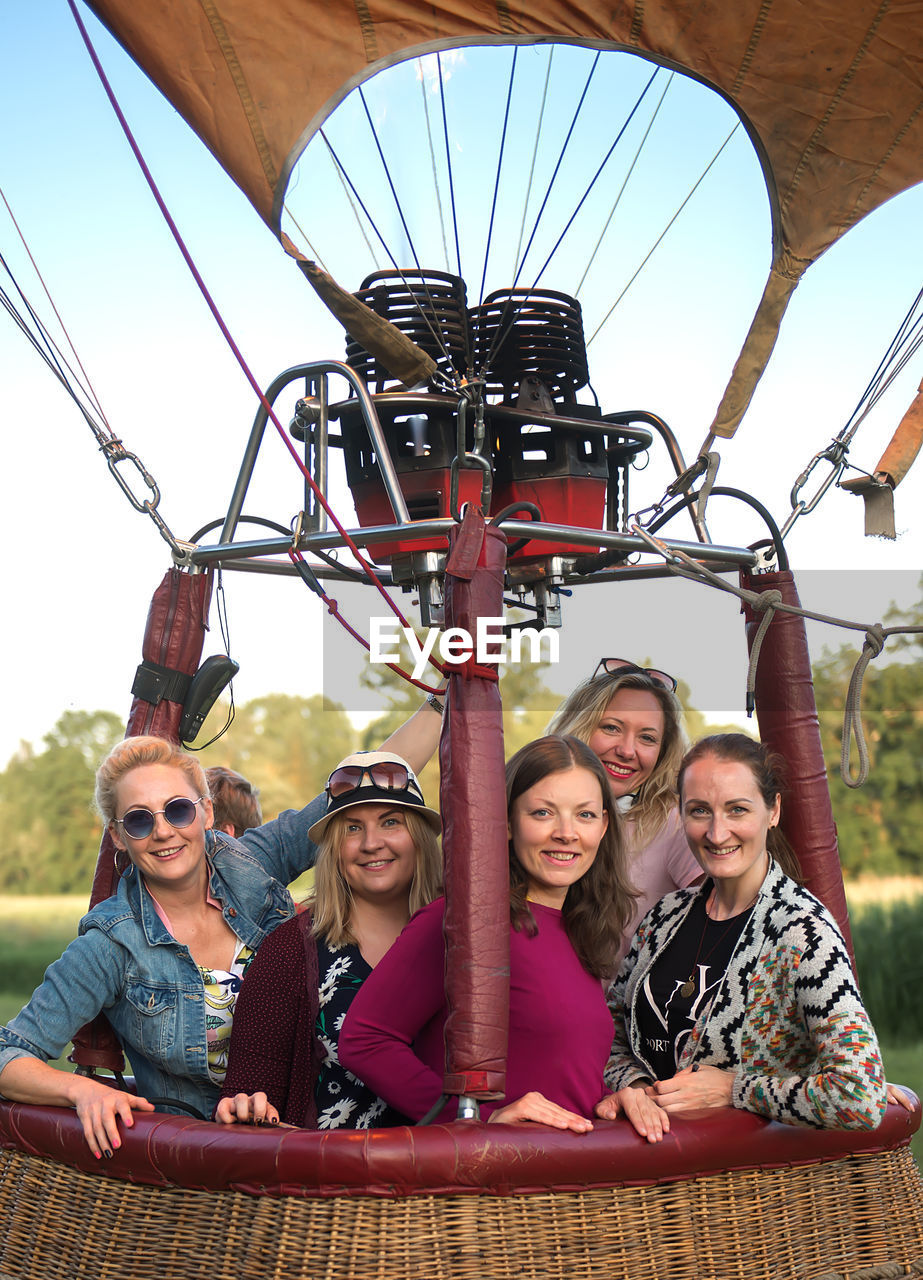 Portrait of friends standing in hot air balloon