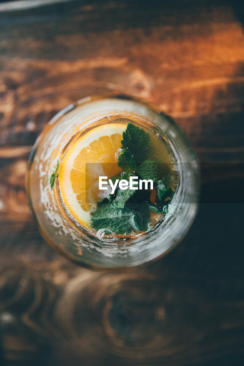 Directly above shot of orange juice in mason jar on table
