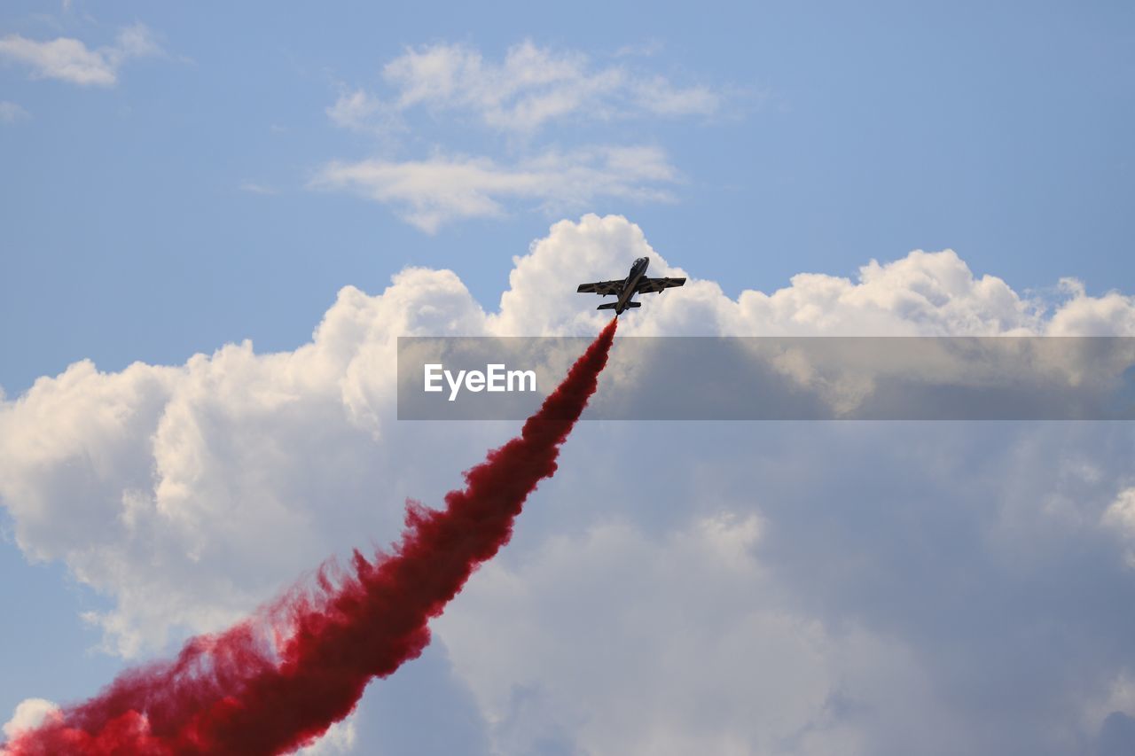 Low angle view of airshow against sky